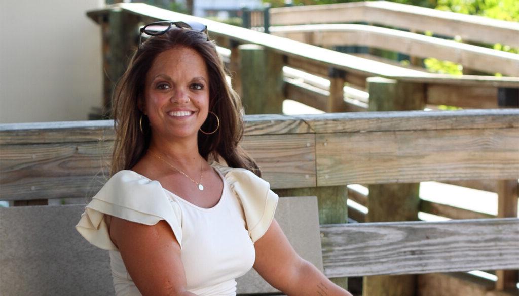 Kristen DeAndrade, sitting outside.